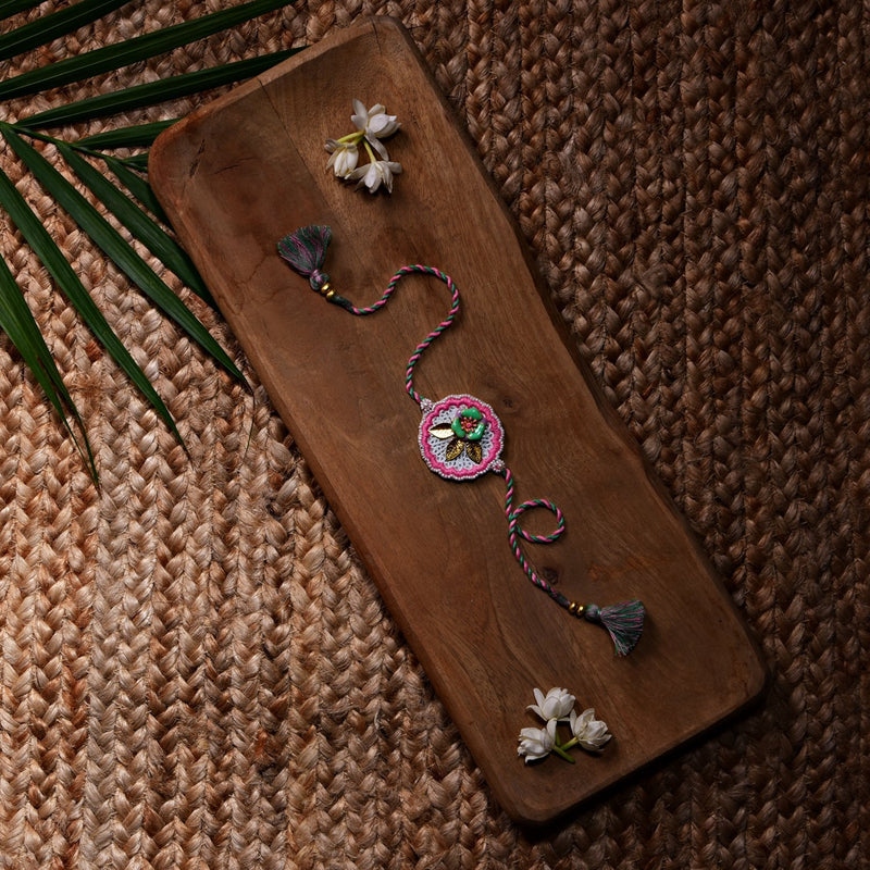 Metal Flower Rakhi With Pink Thread Work