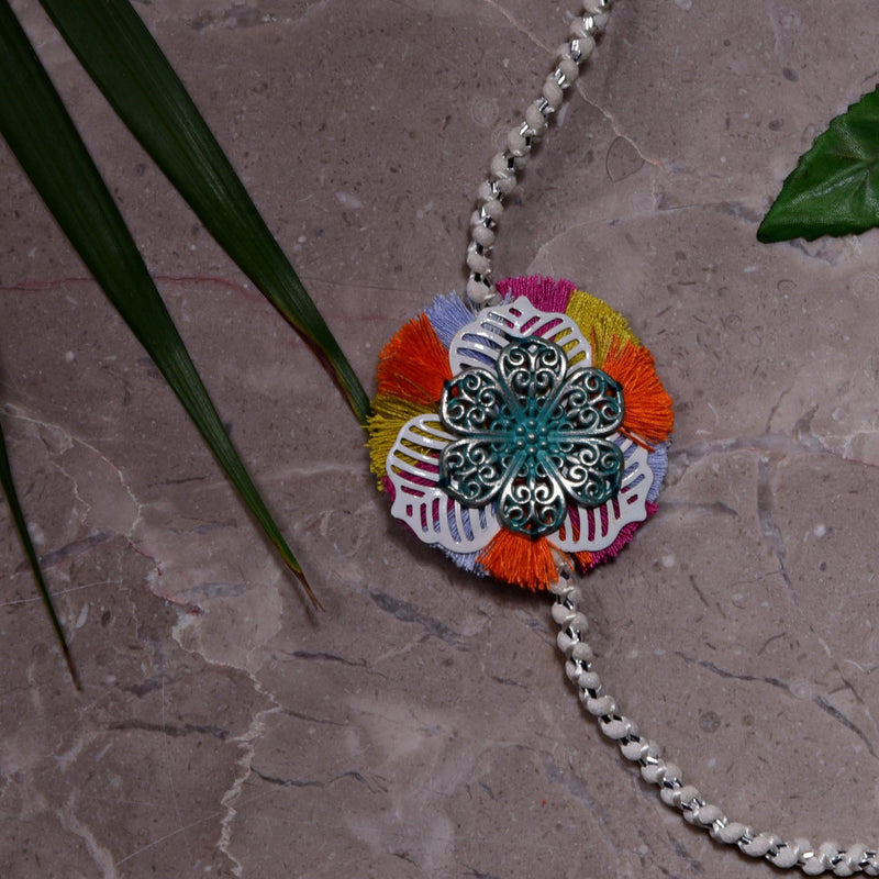 Feroza Metal Flower Rakhi With Pink, Orange & Yellow Fringes