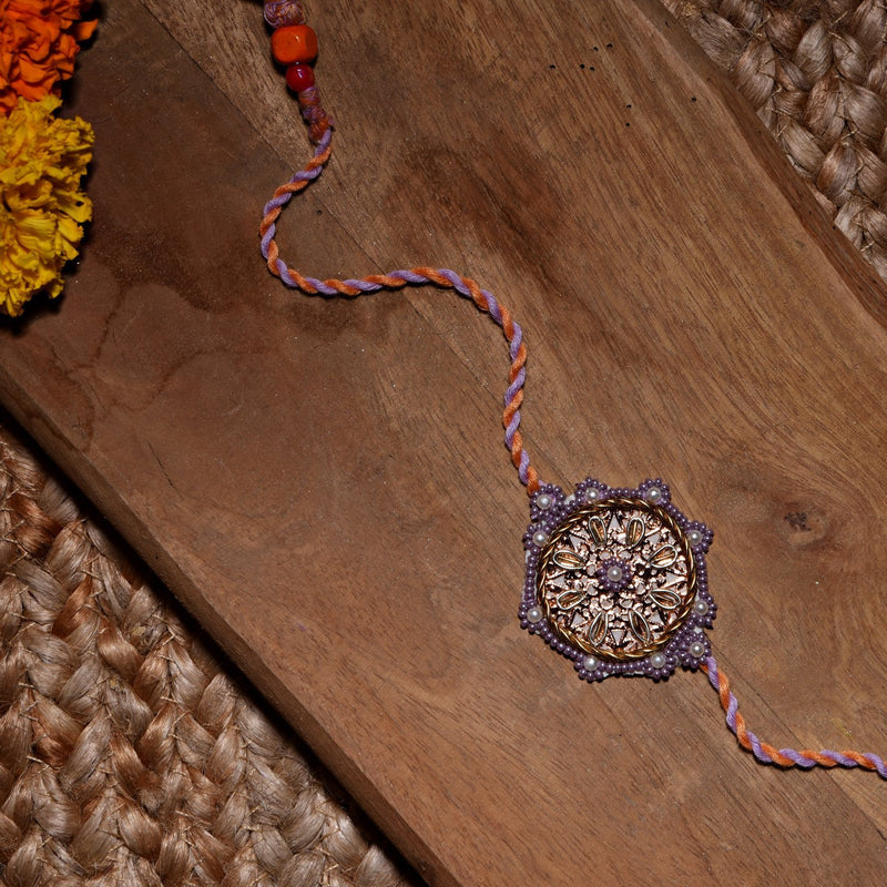 Rose Gold Metal Chakra Rakhi With Lavender Bead Work
